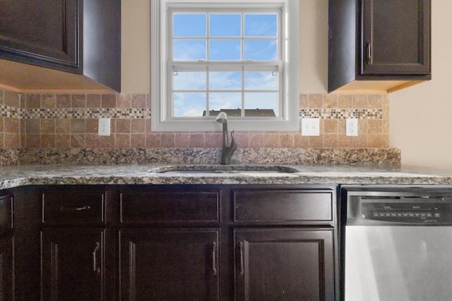 kitchen with dark brown cabinets, backsplash, dishwasher, and a sink