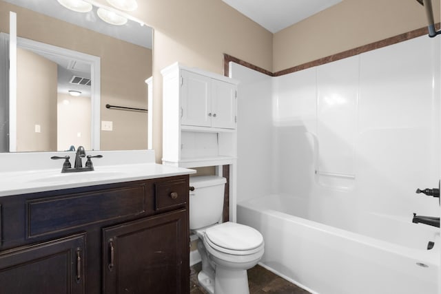 bathroom with visible vents, toilet,  shower combination, and vanity