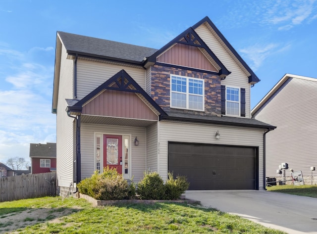 craftsman inspired home featuring concrete driveway, an attached garage, fence, and board and batten siding