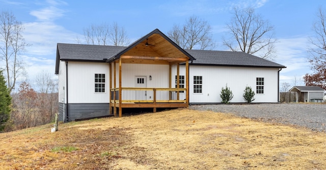 view of front of property with a wooden deck and roof with shingles