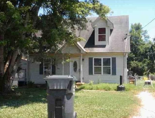 cape cod home with a front yard