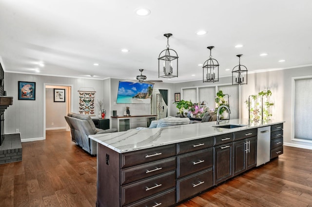 kitchen with dark wood finished floors, a ceiling fan, open floor plan, and a sink