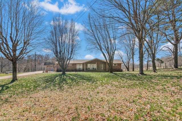 view of yard with a garage and driveway