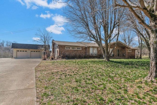 ranch-style home with brick siding, an attached garage, concrete driveway, and a front yard