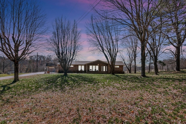 view of front of house featuring a yard and driveway