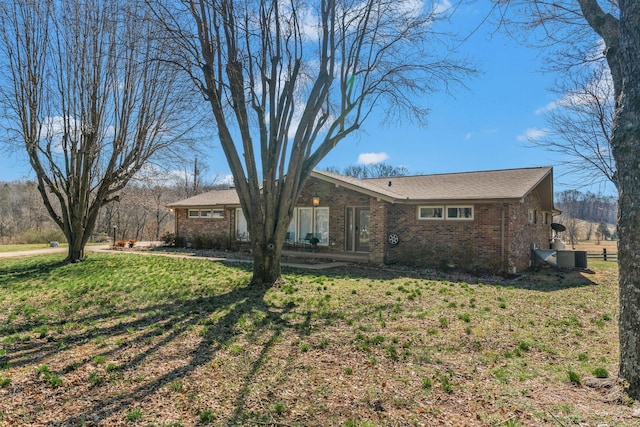 view of front of property with brick siding and a front lawn