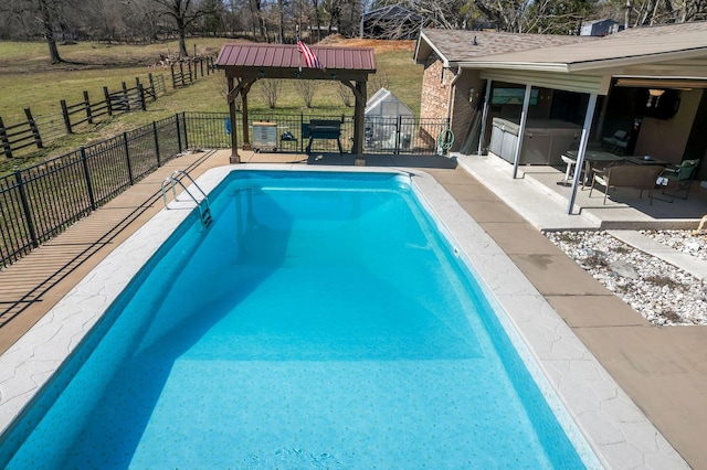 view of swimming pool featuring a patio area, a fenced in pool, a yard, and fence