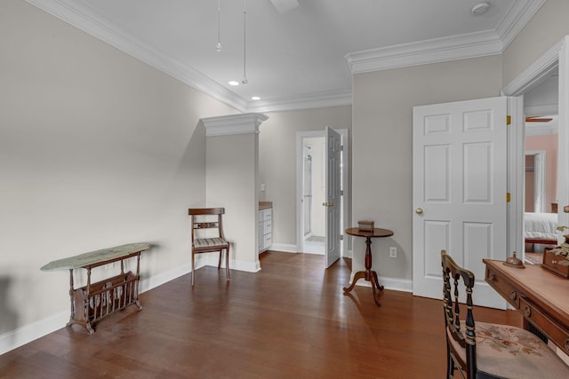 living area featuring a ceiling fan, crown molding, wood finished floors, and baseboards