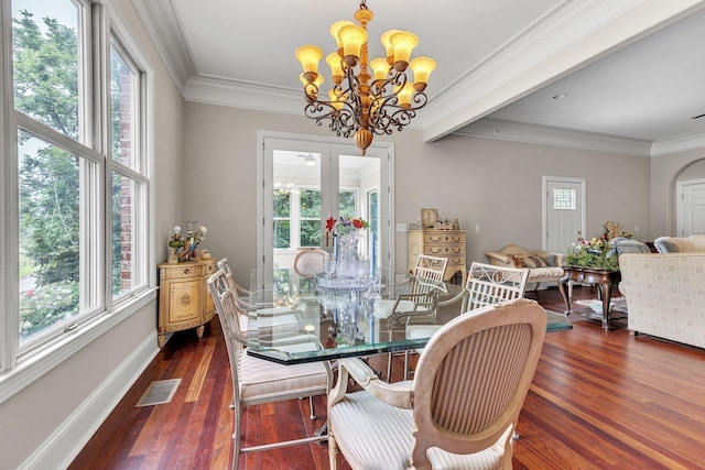 dining space featuring dark wood-style floors, a notable chandelier, a healthy amount of sunlight, and visible vents