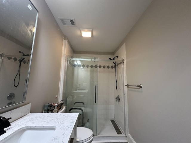 full bath featuring visible vents, toilet, a stall shower, and vanity