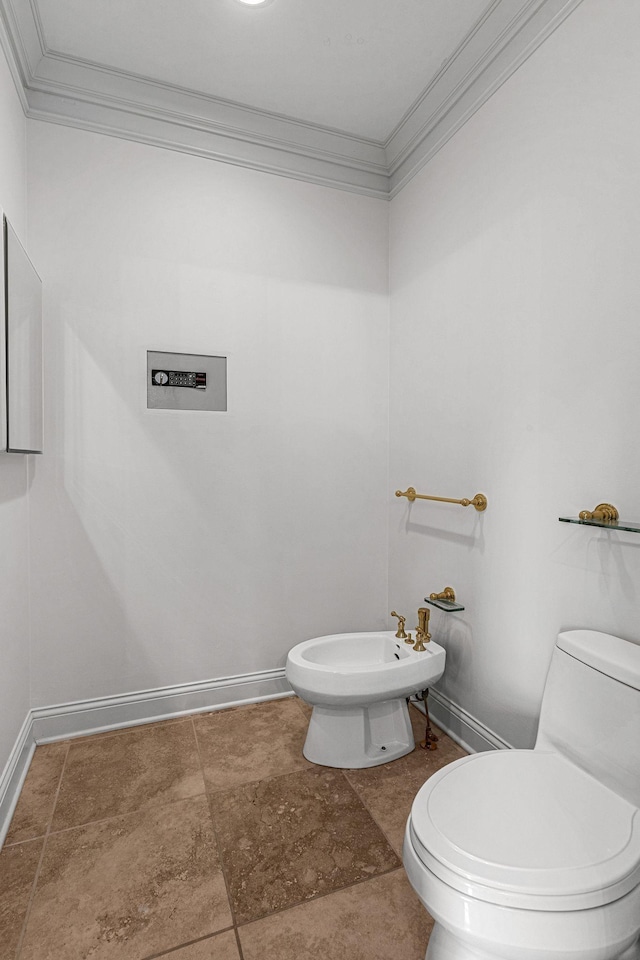 bathroom featuring baseboards, a bidet, toilet, and ornamental molding