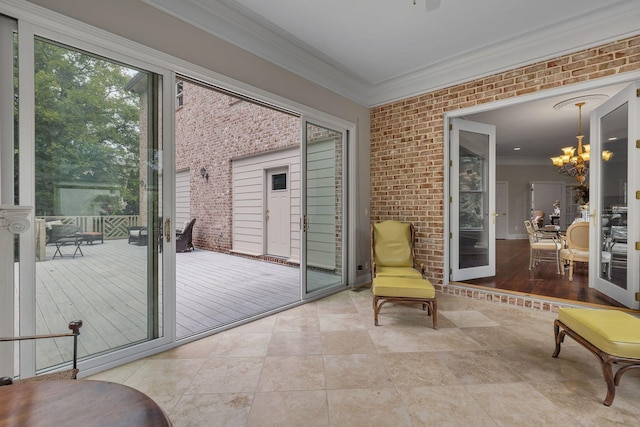 sunroom / solarium with an inviting chandelier