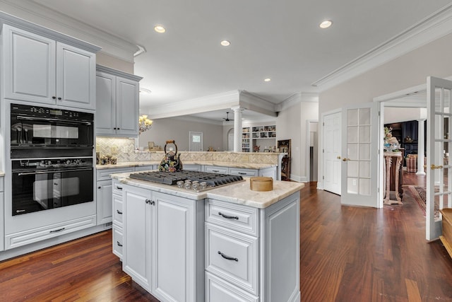 kitchen with dobule oven black, a center island, french doors, crown molding, and stainless steel gas cooktop