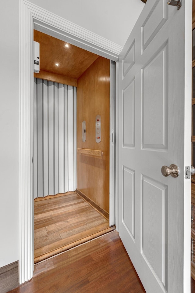 interior space featuring elevator and wood finished floors