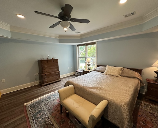 bedroom featuring visible vents, crown molding, baseboards, and wood finished floors