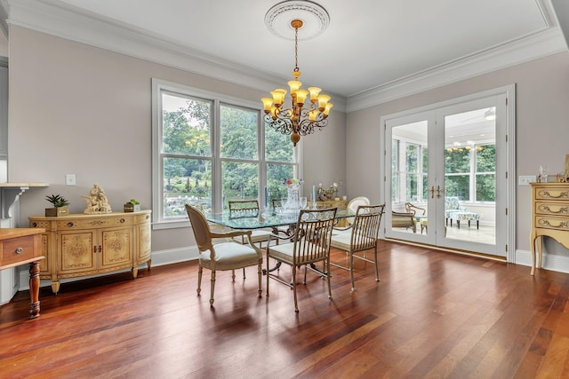 dining area with crown molding, baseboards, a chandelier, french doors, and wood finished floors