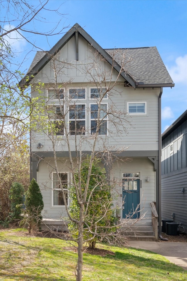 rear view of property with roof with shingles and central AC