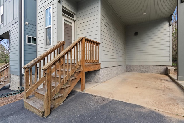 view of exterior entry with a patio area