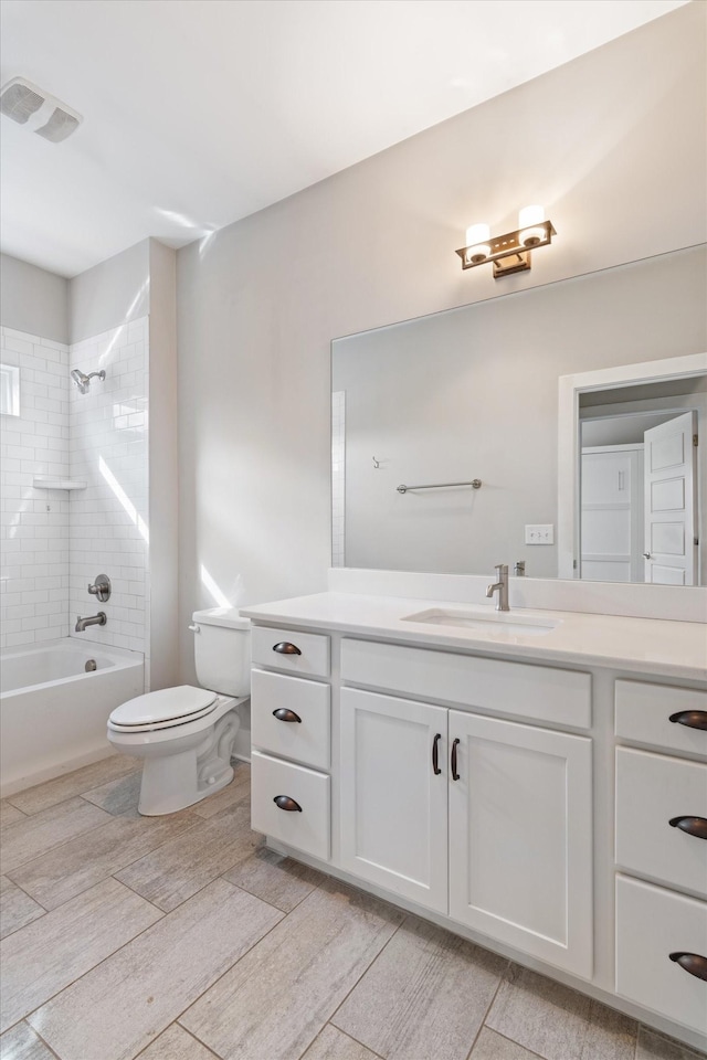 full bath featuring vanity, toilet, tub / shower combination, and visible vents