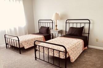 carpeted bedroom featuring baseboards