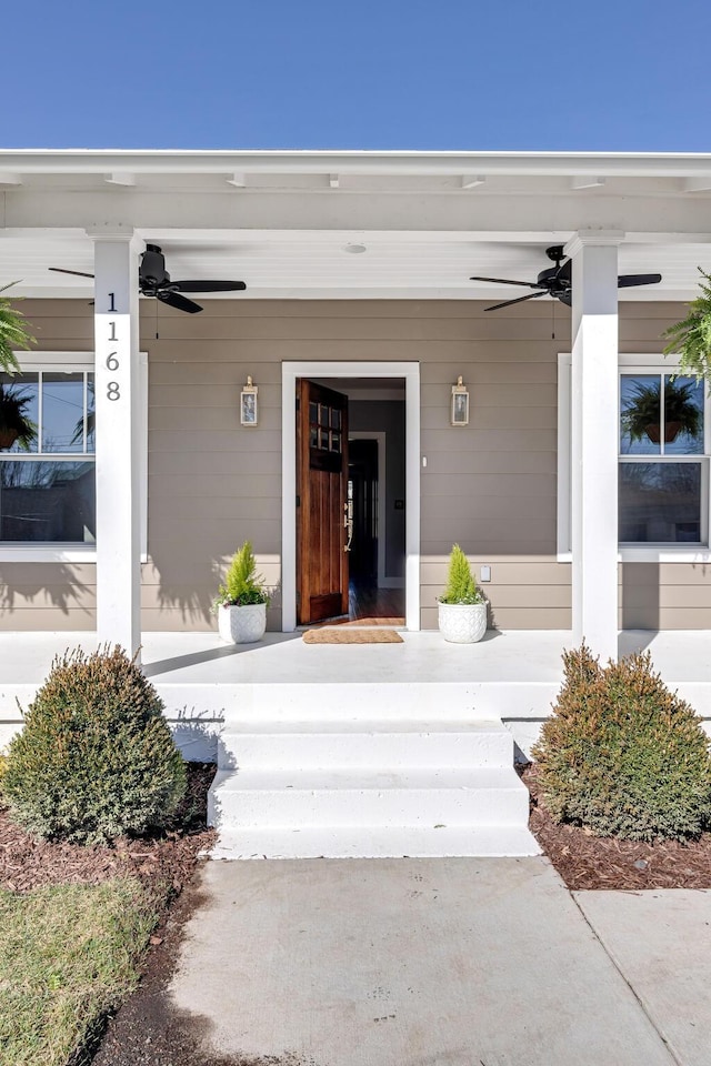 entrance to property with a porch and ceiling fan