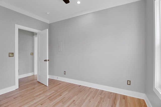 empty room featuring ceiling fan, light wood-type flooring, and baseboards