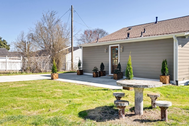 back of house with a yard, a patio, and fence