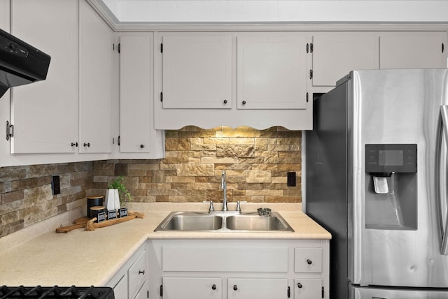 kitchen featuring stainless steel refrigerator with ice dispenser, a sink, tasteful backsplash, white cabinetry, and extractor fan