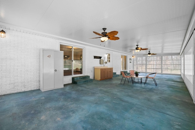 unfurnished sunroom featuring a ceiling fan