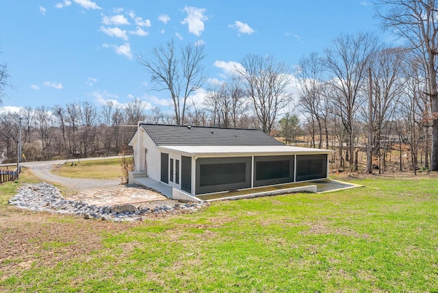 back of property featuring a tiled roof, a lawn, stucco siding, and a sunroom