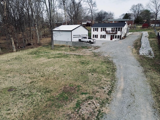 view of front of house with a front lawn, an outbuilding, and driveway