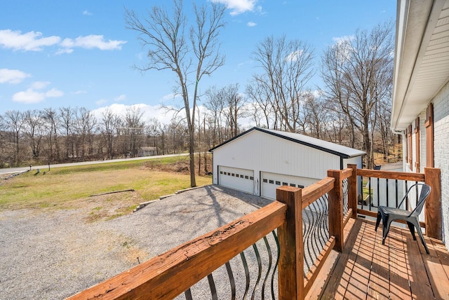 deck with a lawn, an outdoor structure, and a garage