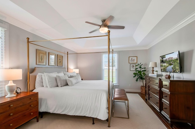 bedroom with crown molding, baseboards, a raised ceiling, and ceiling fan