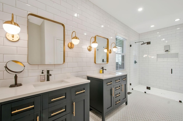 bathroom featuring tiled shower, tile walls, two vanities, and a sink