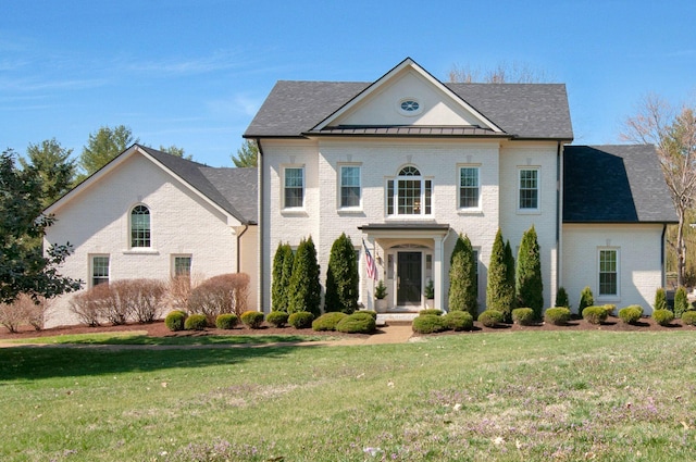 view of front facade featuring brick siding and a front lawn