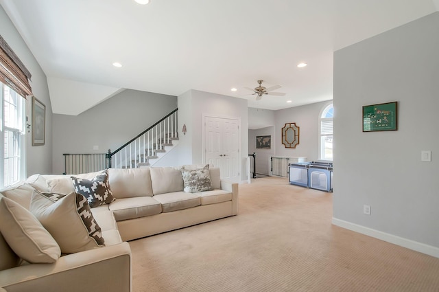 living room featuring recessed lighting, a healthy amount of sunlight, and light carpet