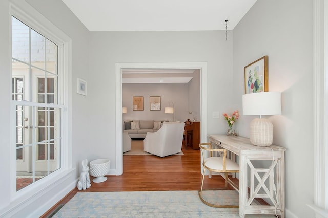 hallway featuring baseboards and wood finished floors