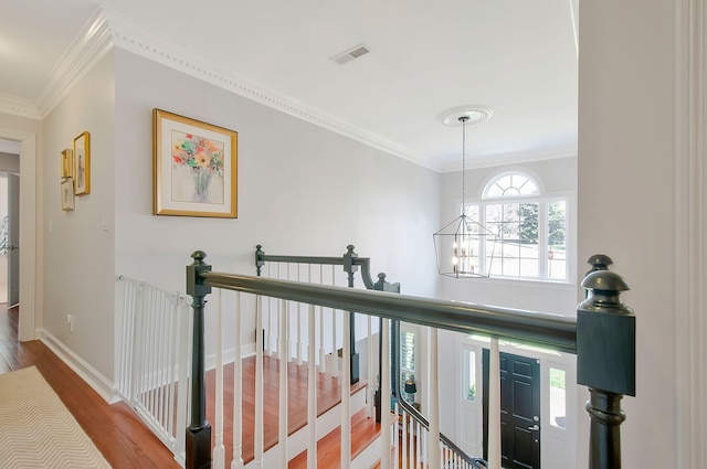 hall featuring an upstairs landing, visible vents, a notable chandelier, and wood finished floors