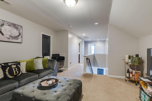 carpeted living room with recessed lighting, baseboards, and visible vents