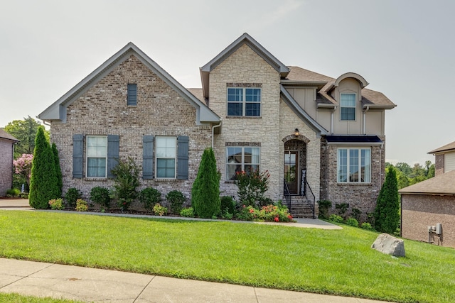 craftsman-style home featuring board and batten siding, a front lawn, and stone siding