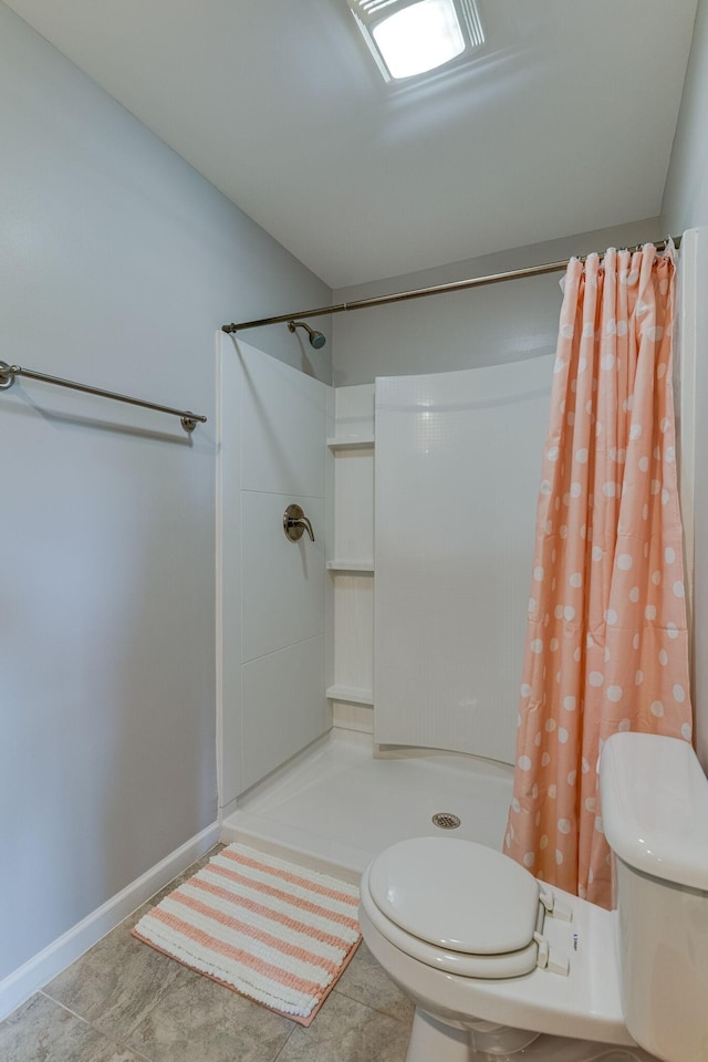 full bath featuring tile patterned floors, toilet, baseboards, and a stall shower