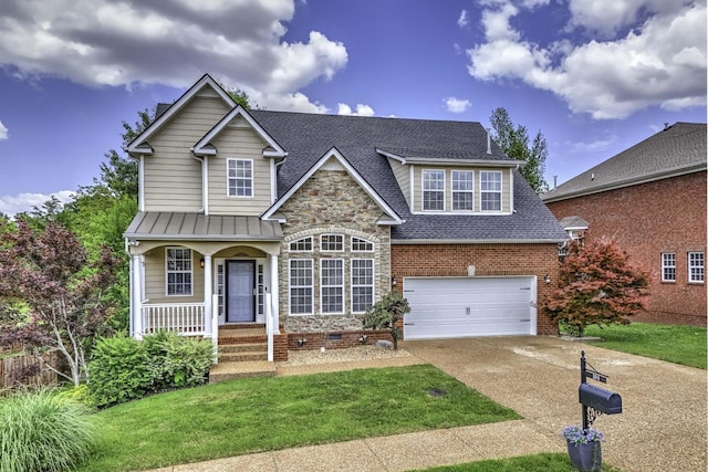 traditional-style house with a porch, concrete driveway, a front yard, roof with shingles, and a garage