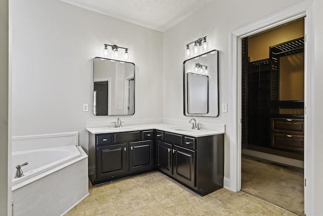 full bathroom featuring a sink, a textured ceiling, a bath, and double vanity