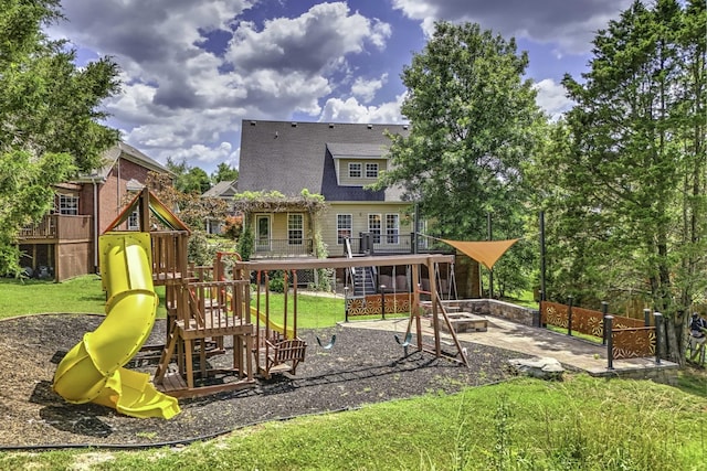 view of play area with a yard, a patio, a fire pit, and fence