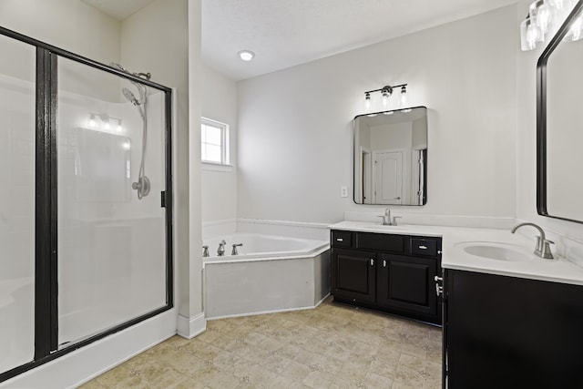 full bath with a stall shower, vanity, and a bath