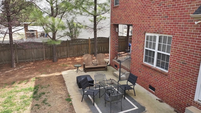 view of patio / terrace featuring fence