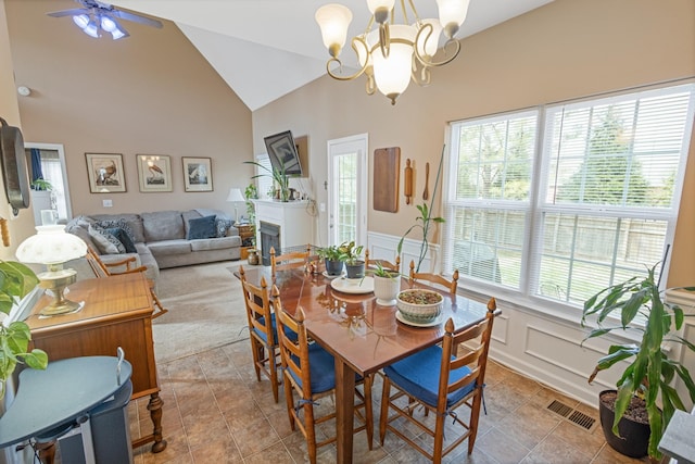 dining space featuring visible vents, plenty of natural light, wainscoting, and ceiling fan with notable chandelier