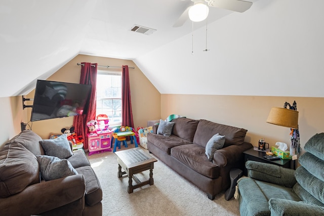 carpeted living area featuring visible vents, a ceiling fan, and vaulted ceiling