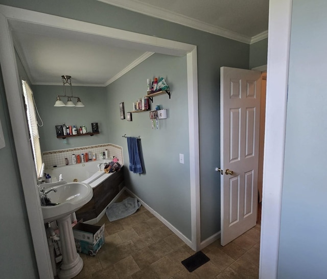 full bathroom featuring crown molding, baseboards, a whirlpool tub, and a sink