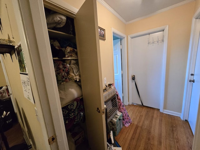 corridor featuring crown molding and wood finished floors